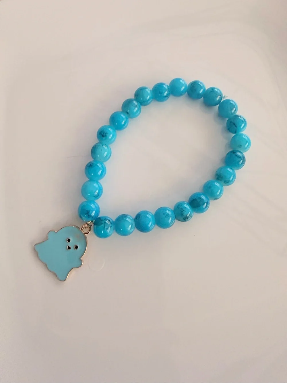 Blue Beaded Bracelet with Playful Ghost Charm